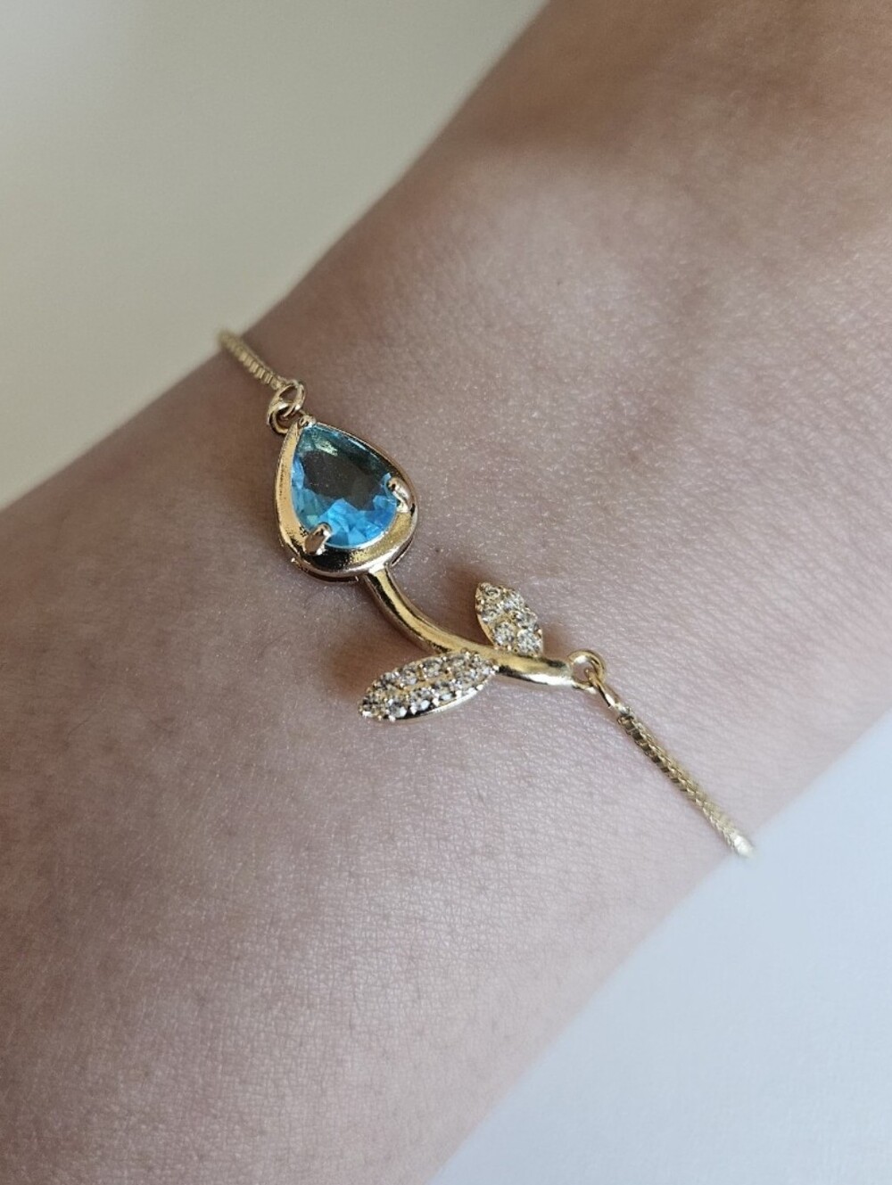 Gold Plated Tulip Adjustable Bracelet with Blue Teardrop Gem and Pavé Leaves